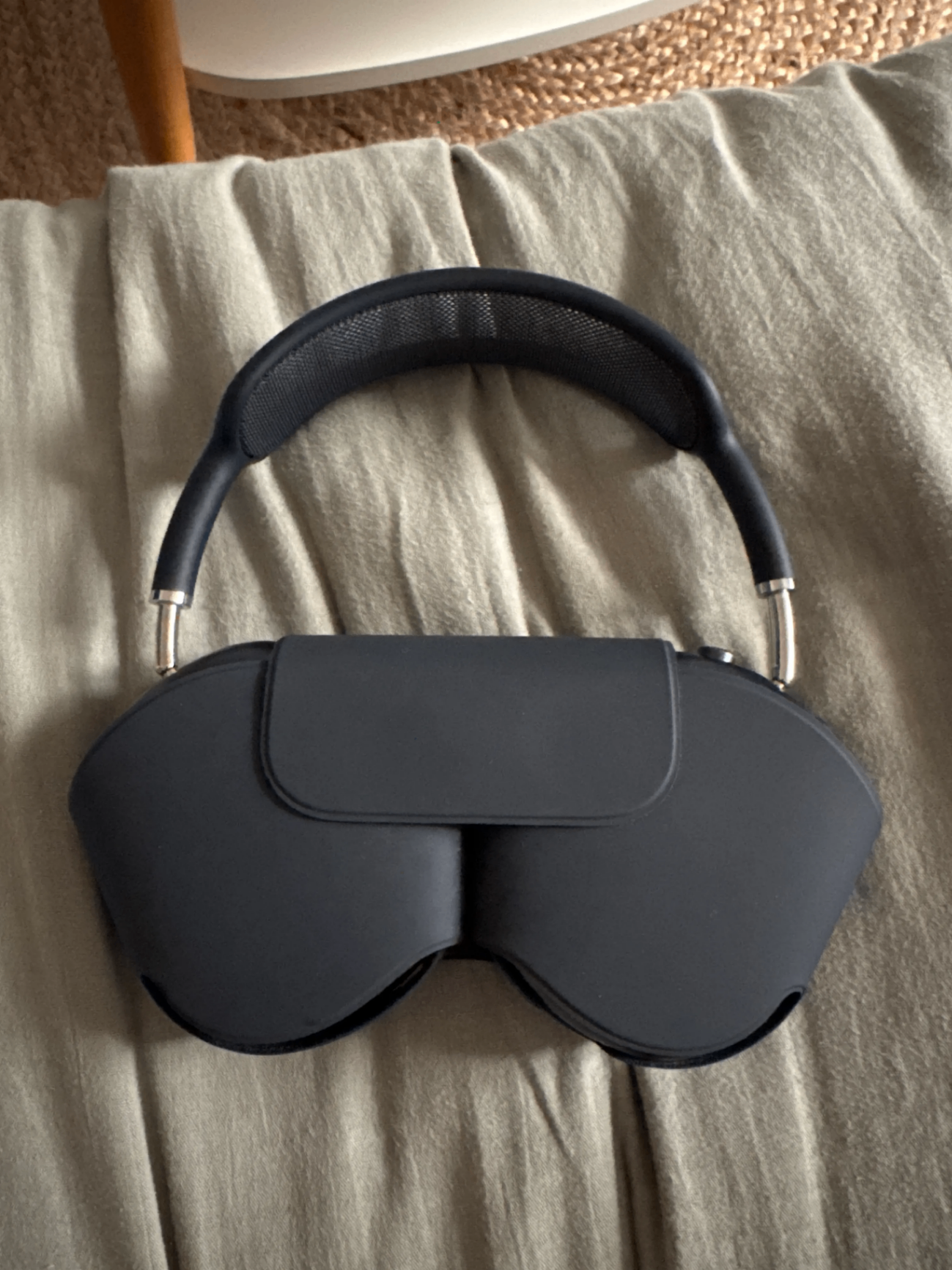Black headphones resting on top of their case